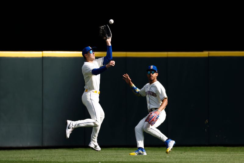 Oct 1, 2023; Seattle, Washington, USA; Seattle Mariners left fielder Dominic Canzone (8) catches a fly ball against the Texas Rangers during the first inning at T-Mobile Park. Seattle Mariners center fielder Julio Rodriguez (44) backs up the play at right. Mandatory Credit: Joe Nicholson-USA TODAY Sports