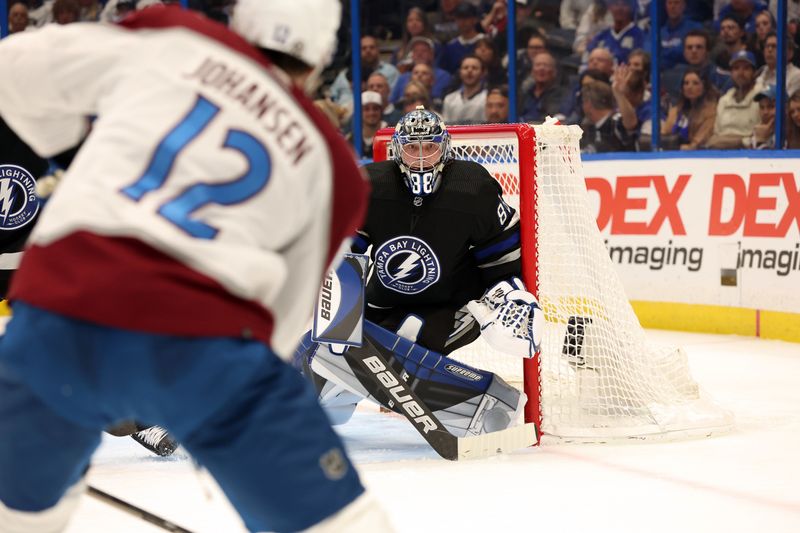 Feb 15, 2024; Tampa, Florida, USA; Colorado Avalanche center Ryan Johansen (12) shoots as Tampa Bay Lightning goaltender Andrei Vasilevskiy (88) makes a save during the second period at Amalie Arena. Mandatory Credit: Kim Klement Neitzel-USA TODAY Sports