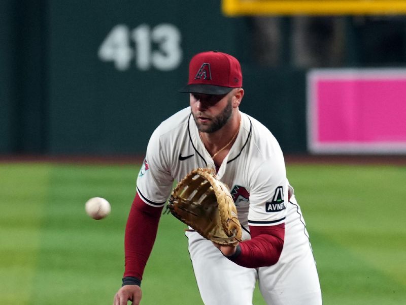 May 3, 2024; Phoenix, Arizona, USA; Arizona Diamondbacks first base Christian Walker (53) fields a ground ball against the San Diego Padres during the fifth inning at Chase Field. Mandatory Credit: Joe Camporeale-USA TODAY Sports