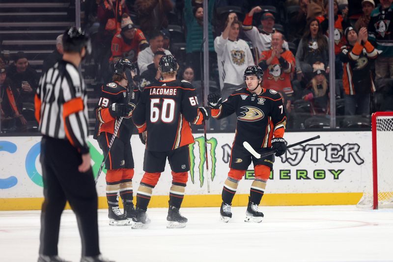 Mar 1, 2024; Anaheim, California, USA; Anaheim Ducks right wing Frank Vatrano (77) celebrates with right wing Troy Terry (19) and defenseman Jackson LaCombe (60) after scoring a goal against New Jersey Devils goaltender Nico Daws (50) during the first period at Honda Center. Mandatory Credit: Kiyoshi Mio-USA TODAY Sports