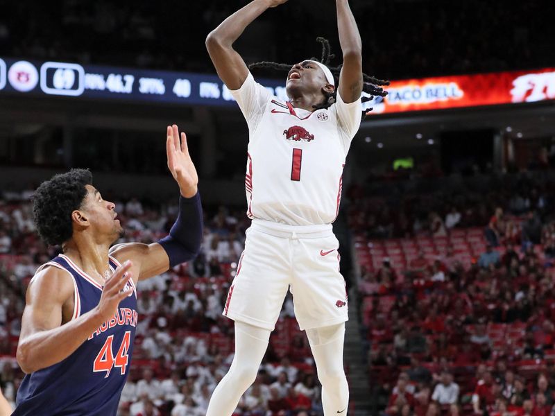 Jan 6, 2024; Fayetteville, Arkansas, USA; Arkansas Razorbacks guard Keyon Menifield Jr (1) shoots in the second half as Auburn Tigers center Dylan Cardwell (44) defends at Bud Walton Arena. Auburn won 83-51. Mandatory Credit: Nelson Chenault-USA TODAY Sports