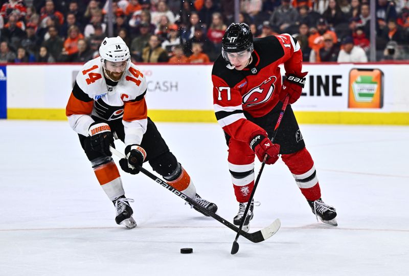 Apr 13, 2024; Philadelphia, Pennsylvania, USA; New Jersey Devils defenseman Simon Nemec (17) and Philadelphia Flyers center Sean Couturier (14) battle for the puck in the third period at Wells Fargo Center. Mandatory Credit: Kyle Ross-USA TODAY Sports