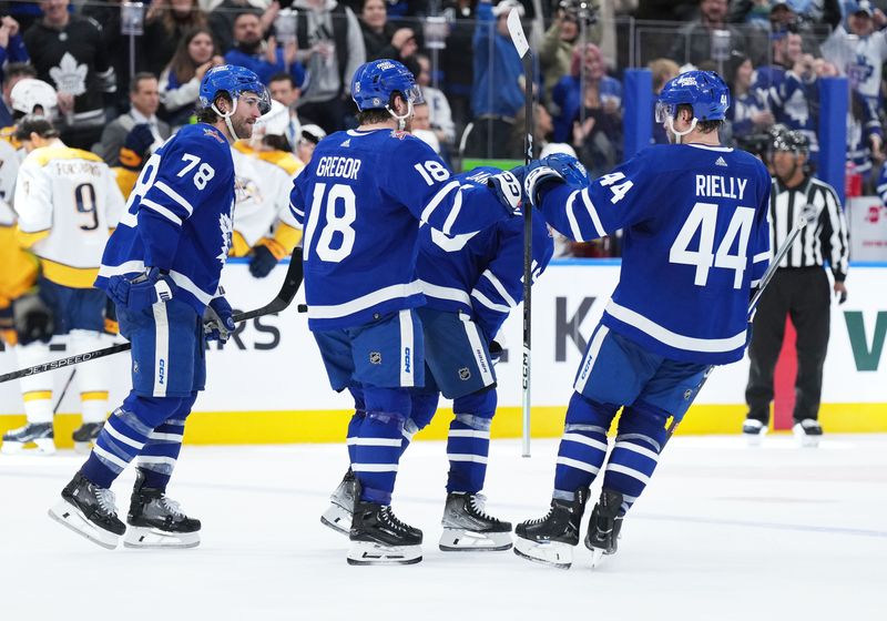 Dec 9, 2023; Toronto, Ontario, CAN; Toronto Maple Leafs center Noah Gregor (18) scores an empty net goal and celebrates with Toronto Maple Leafs defenseman Morgan Rielly (44) against the Nashville Predators during the third period at Scotiabank Arena. Mandatory Credit: Nick Turchiaro-USA TODAY Sports