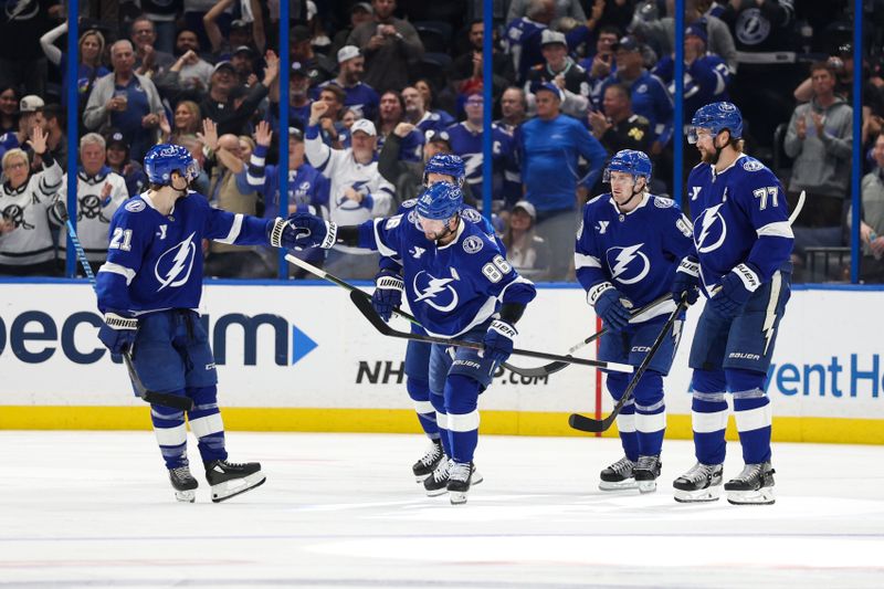 Mar 4, 2025; Tampa, Florida, USA; Tampa Bay Lightning right wing Mitchell Chaffee (41) celebrates with center Brayden Point (21) after scoring a goal against the Columbus Blue Jackets in the first period  at Amalie Arena. Mandatory Credit: Nathan Ray Seebeck-Imagn Images