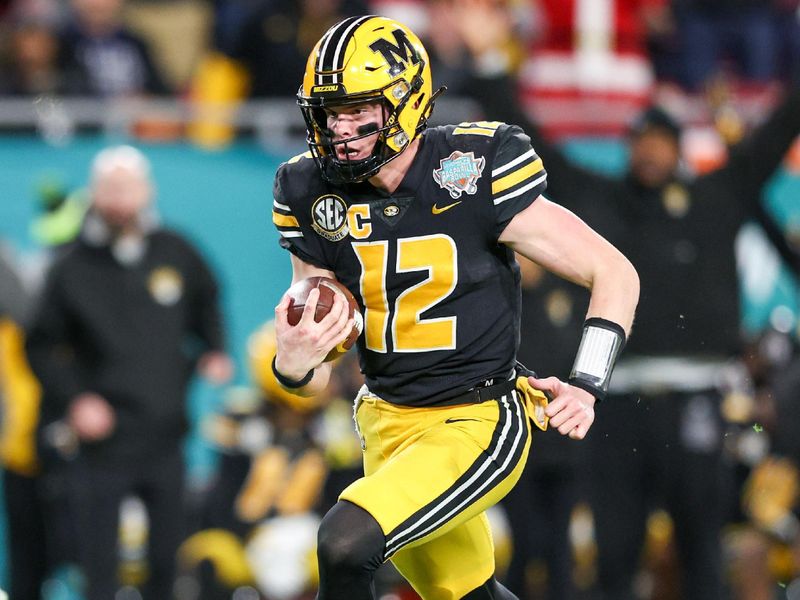 Dec 23, 2022; Tampa, Florida, USA; Missouri Tigers quarterback Brady Cook (12) runs with the ball against the Wake Forest Demon Deacons in the second quarter in the 2022 Gasparilla Bowl at Raymond James Stadium. Mandatory Credit: Nathan Ray Seebeck-USA TODAY Sports