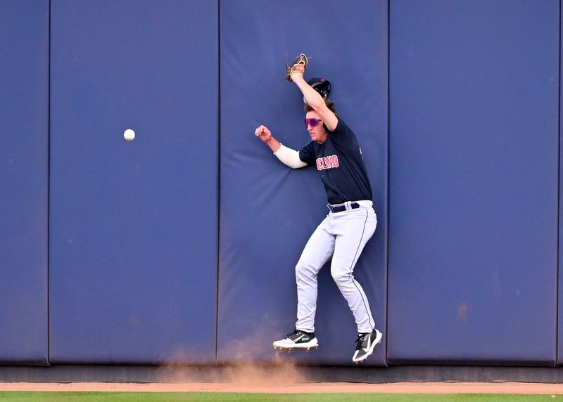 Feb 28, 2023; Peoria, Arizona, USA; Cleveland Guardians center fielder Petey Halpin (16) hits the wall in the second inning of a spring training game against the Seattle Mariners at the Peoria Sports Complex. Mandatory Credit: Jayne Kamin-Oncea-USA TODAY Sports