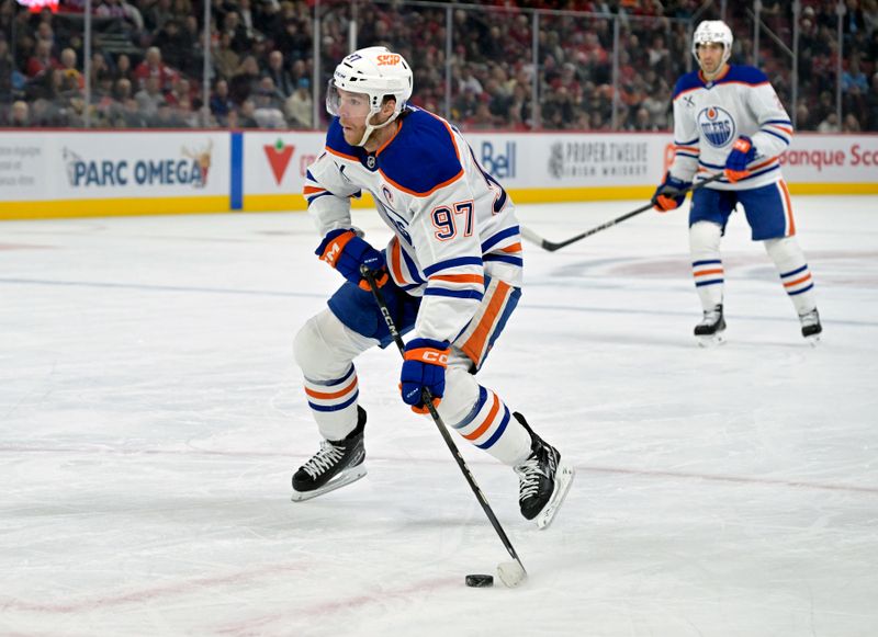 Nov 18, 2024; Montreal, Quebec, CAN;  Edmonton Oilers forward Connor McDavid (97) plays the puck against the Montreal Canadiens during the first period at the Bell Centre. Mandatory Credit: Eric Bolte-Imagn Images