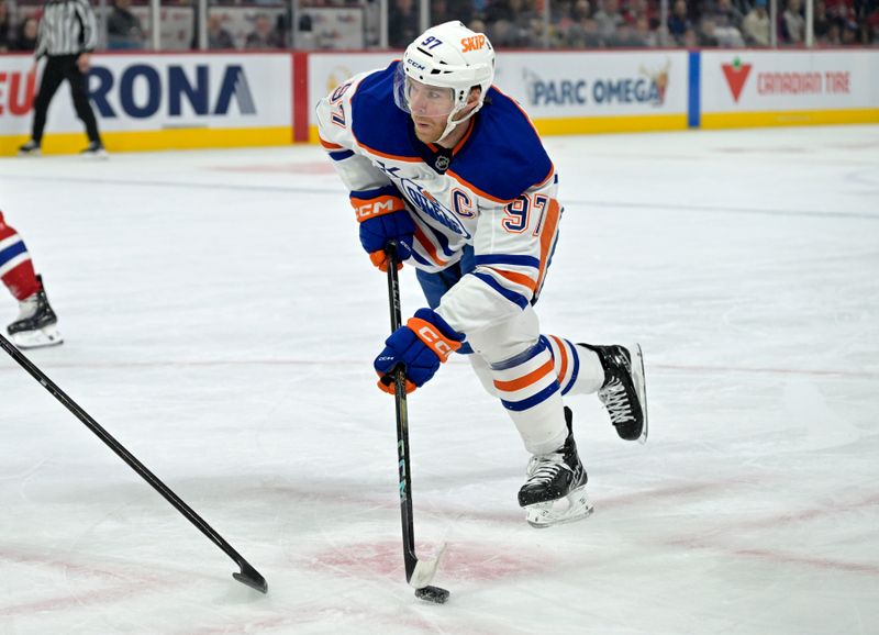 Nov 18, 2024; Montreal, Quebec, CAN;  Edmonton Oilers forward Connor McDavid (97) plays the puck against the Montreal Canadiens during the first period at the Bell Centre. Mandatory Credit: Eric Bolte-Imagn Images