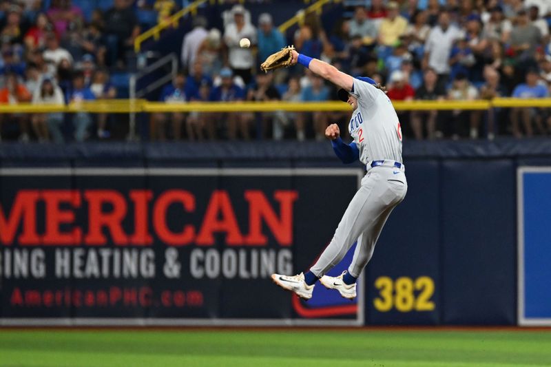 Jun 12, 2024; St. Petersburg, Florida, USA;  Chicago Cubs second baseman Nico Hoerner (2) attempts to catch a line drive in the fifth inning against the Tampa Bay Rays at Tropicana Field. Mandatory Credit: Jonathan Dyer-USA TODAY Sports