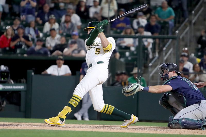 May 5, 2025; West Sacramento, California, USA; Athletics shortstop Jacob Wilson (5) hits a walk-off RBI single against the Seattle Mariners during the eleventh inning at Sutter Health Park. Mandatory Credit: Dennis Lee-Imagn Images
