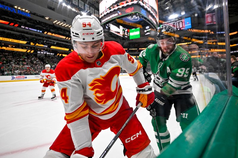 Mar 6, 2025; Dallas, Texas, USA; Calgary Flames defenseman Brayden Pachal (94) and Dallas Stars center Matt Duchene (95) battle for control of the puck during the second period at the American Airlines Center. Mandatory Credit: Jerome Miron-Imagn Images