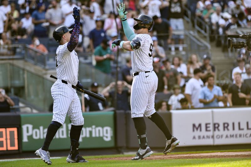 Jun 20, 2024; Bronx, New York, USA; New York Yankees outfielder Aaron Judge (99) high fives designated hitter Giancarlo Stanton (27) after hitting a two-run home run against the Baltimore Orioles during the third inning at Yankee Stadium. Mandatory Credit: John Jones-USA TODAY Sports