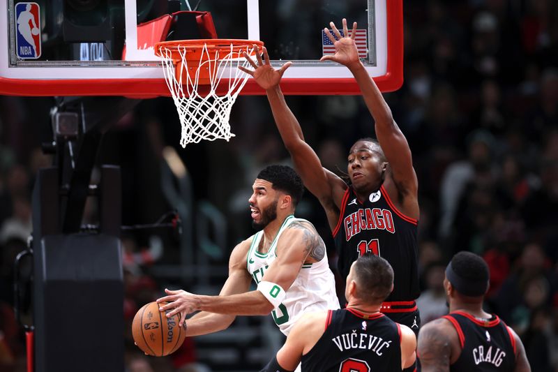 CHICAGO, ILLINOIS - NOVEMBER 29: Jayson Tatum #0 of the Boston Celtics looks to shoot the ball against Ayo Dosunmu #11 of the Chicago Bulls during the third quarter of the Emirates NBA Cup game at the United Center on November 29, 2024 in Chicago, Illinois. NOTE TO USER: User expressly acknowledges and agrees that, by downloading and or using this photograph, User is consenting to the terms and conditions of the Getty Images License Agreement.  (Photo by Luke Hales/Getty Images)