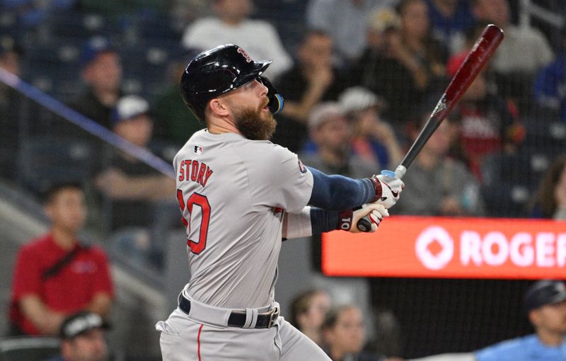 Sep 24, 2024; Toronto, Ontario, CAN;  Boston Red Sox shortstop Trevor Story (10) hits an RBI single against the Toronto Blue Jays in the tenth inning at Rogers Centre. Mandatory Credit: Dan Hamilton-Imagn Images