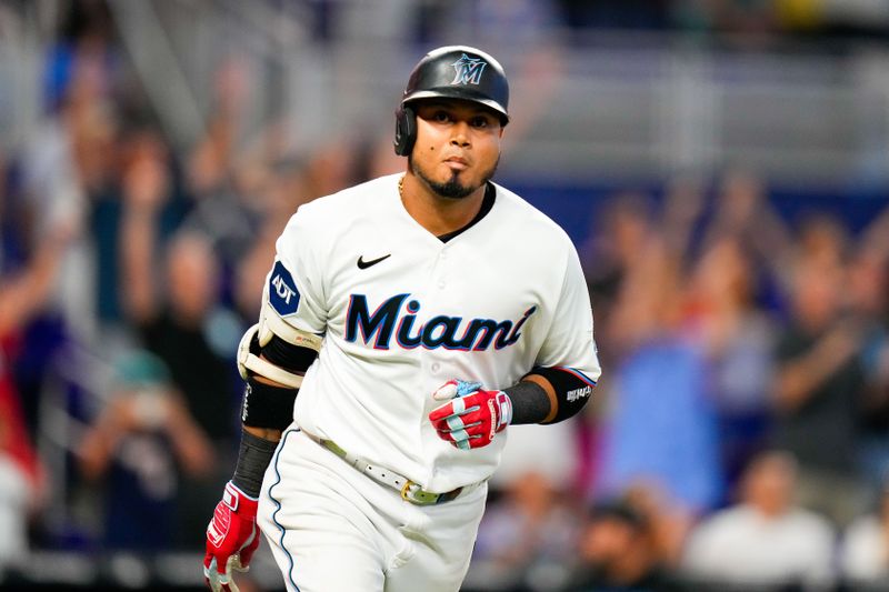 Jul 23, 2023; Miami, Florida, USA; Miami Marlins second baseman Luis Arraez (3) runs to first base after hitting the winning hit against the Colorado Rockies during the tenth inning at loanDepot Park. Mandatory Credit: Rich Storry-USA TODAY Sports