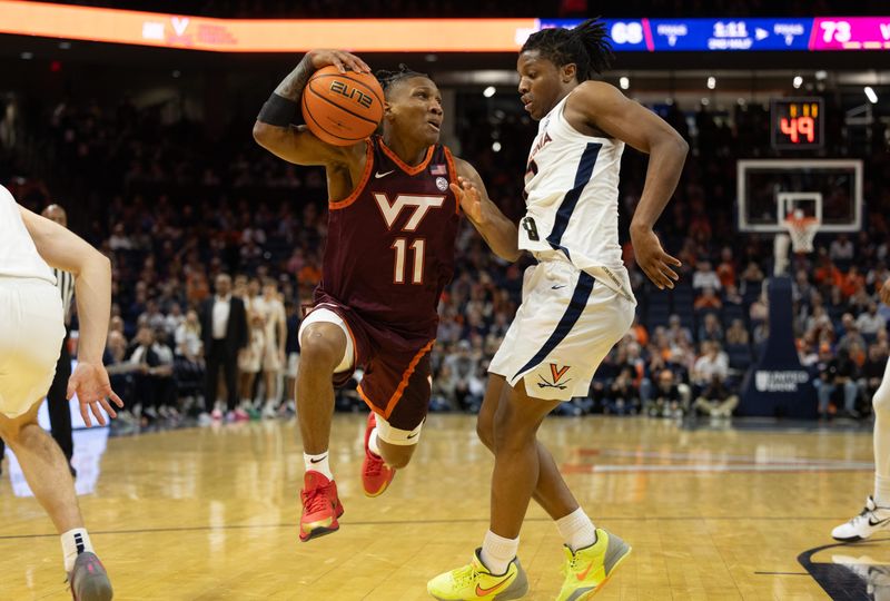 Feb 1, 2025; Charlottesville, Virginia, USA; Virginia Tech Hokies guard Ben Hammond (11) controls the ball as Virginia Cavaliers guard Dai Dai Ames (7) defends in the second half at John Paul Jones Arena. Mandatory Credit: Emily Morgan-Imagn Images