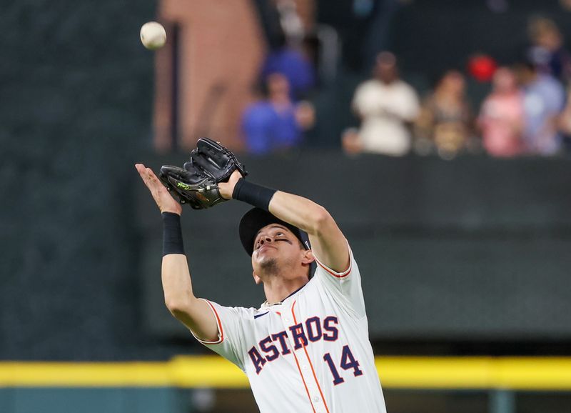 Sep 19, 2024; Houston, Texas, USA;  Houston Astros second baseman Mauricio Dubon (14) catches Los Angeles Angels right fielder Gustavo Campero (51) (not pictured) infield fly ball for an out in the second inning at Minute Maid Park. Mandatory Credit: Thomas Shea-Imagn Images