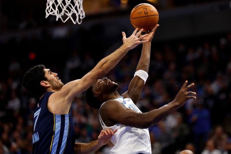 MINNEAPOLIS, MINNESOTA - JANUARY 18: Anthony Edwards #5 of the Minnesota Timberwolves is fouled by Santi Aldama #7 of the Memphis Grizzlies in the third quarter at Target Center on January 18, 2024 in Minneapolis, Minnesota. The Timberwolves defeated the Grizzlies 118-103. NOTE TO USER: User expressly acknowledges and agrees that, by downloading and or using this photograph, User is consenting to the terms and conditions of the Getty Images License Agreement. (Photo by David Berding/Getty Images)