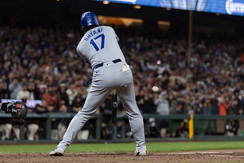 May 15, 2024; San Francisco, California, USA; Los Angeles Dodgers designated hitter Shohei Ohtani (17) hits a single against the San Francisco Giants during the ninth inning at Oracle Park. Mandatory Credit: John Hefti-USA TODAY Sports