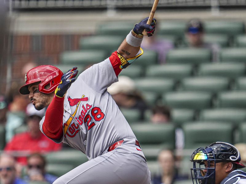 Apr 23, 2025; Cumberland, Georgia, USA; St. Louis Cardinals third base Nolan Arenado (28) hits a double to drive in a run against the Atlanta Braves during the first inning at Truist Park. Mandatory Credit: Dale Zanine-Imagn Images