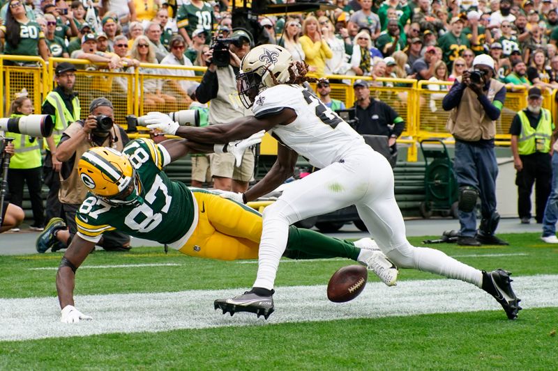 New Orleans Saints cornerback Isaac Yiadom (27) breaks up a pass intended for Green Bay Packers wide receiver Romeo Doubs (87) during the second half of an NFL football game Sunday, Sept. 24, 2023, in Green Bay, Wis. (AP Photo/Morry Gash)