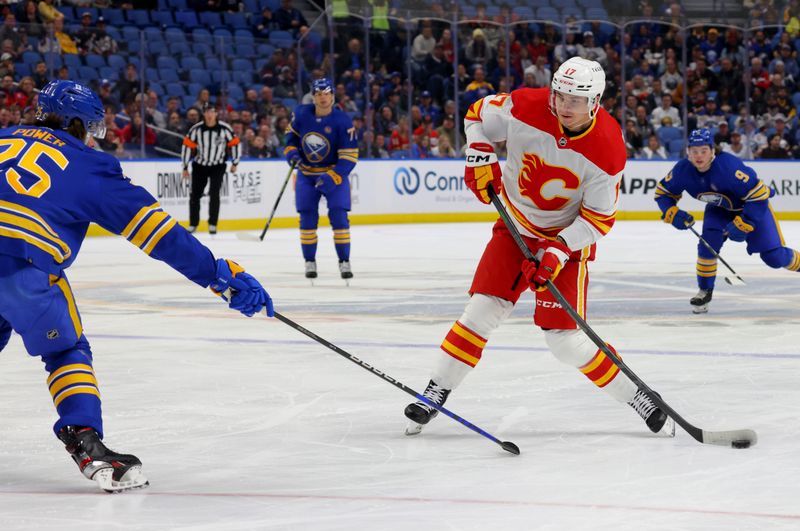 Oct 19, 2023; Buffalo, New York, USA;  Buffalo Sabres defenseman Owen Power (25) tries to block a shot by Calgary Flames center Yegor Sharangovich (17) during the first period at KeyBank Center. Mandatory Credit: Timothy T. Ludwig-USA TODAY Sports