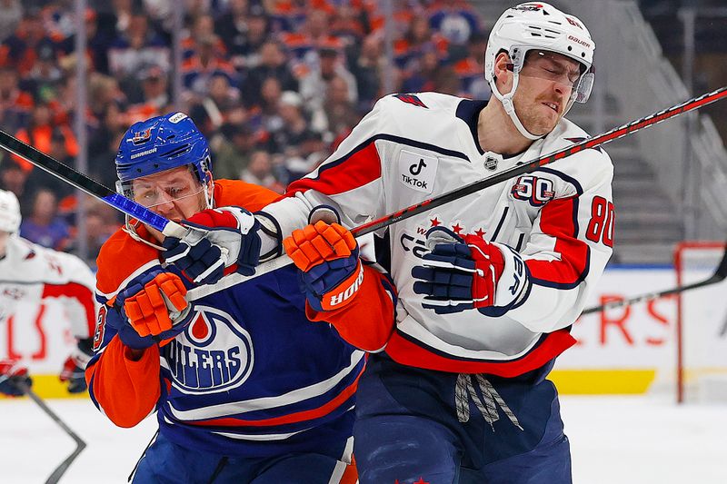 Jan 21, 2025; Edmonton, Alberta, CAN; Edmonton Oilers forward Mattias Janmark (13) and Washington Capitals forward Pierre-Luc Dubois (80) battle for position during the first period at Rogers Place. Mandatory Credit: Perry Nelson-Imagn Images
