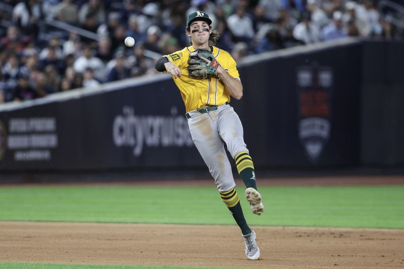 Jun 27, 2025; Bronx, New York, USA;  Athletics shortstop Jacob Wilson (5) makes a running throw to first base for an assist in the seventh inning against the New York Yankees at Yankee Stadium. Mandatory Credit: Wendell Cruz-Imagn Images