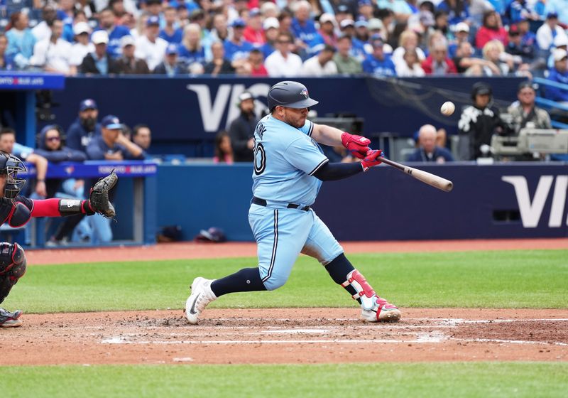 Aug 30, 2023; Toronto, Ontario, CAN; Toronto Blue Jays catcher Alejandro Kirk (30) hits an RBI sacrifice fly ball against the Washington Nationals during the seventh inning at Rogers Centre. Mandatory Credit: Nick Turchiaro-USA TODAY Sports