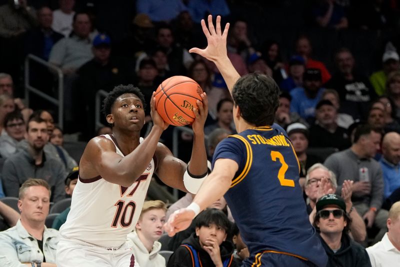 Mar 11, 2025; Charlotte, NC, USA; Virginia Tech Hokies guard Tyler Johnson (10) shoots as California Golden Bears guard Andrej Stojakovic (2) defends in the first half at Spectrum Center. Mandatory Credit: Bob Donnan-Imagn Images
