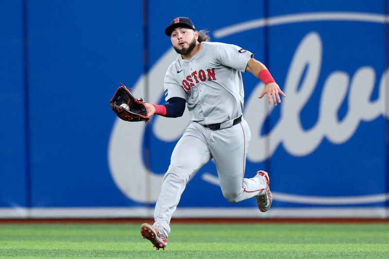 Sep 19, 2024; St. Petersburg, Florida, USA; Boston Red Sox outfielder Wilyer Abreu (52) catches a fly ball against the Tampa Bay Rays in the third inning at Tropicana Field. Mandatory Credit: Nathan Ray Seebeck-Imagn Images