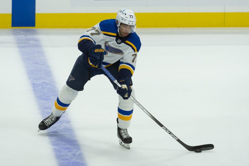 Oct 29, 2024; Ottawa, Ontario, CAN; St. Louis Blues defenseman Pierre-Olivier Joseph (77) shoots the puck in the third period against the Ottawa Senators at the Canadian Tire Centre. Mandatory Credit: Marc DesRosiers-Imagn Images