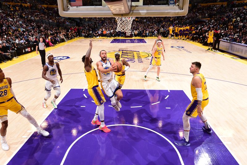 LOS ANGELES, CA - APRIL 3:   Stephen Curry #30 of the Golden State Warriors drives to the basket during the game against the Los Angeles Lakers  on April 3, 2025 at Crypto.Com Arena in Los Angeles, California. NOTE TO USER: User expressly acknowledges and agrees that, by downloading and/or using this Photograph, user is consenting to the terms and conditions of the Getty Images License Agreement. Mandatory Copyright Notice: Copyright 2025 NBAE (Photo by Adam Pantozzi/NBAE via Getty Images)