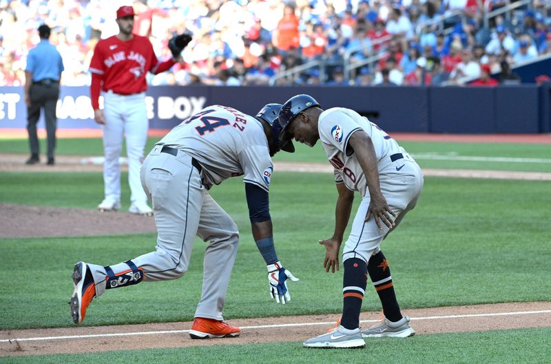 Jul 1, 2024; Toronto, Ontario, CAN;  Houston Astros designated hitter Yordan Alvarez (44) celebrates with third base coach Gary Pettis (8) after hitting a two run home run as Toronto Blue Jays pitcher Zach Pop (56) waits for a new ball in the ninth inning at Rogers Centre. Mandatory Credit: Dan Hamilton-USA TODAY Sports