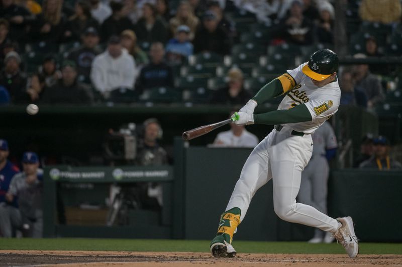Apr 24, 2025; West Sacramento, California, USA; Athletics first baseman Tyler Soderstrom (21) hits an rbi double against the Texas Rangers during the third inning at Sutter Health Park. Mandatory Credit: Ed Szczepanski-Imagn Images