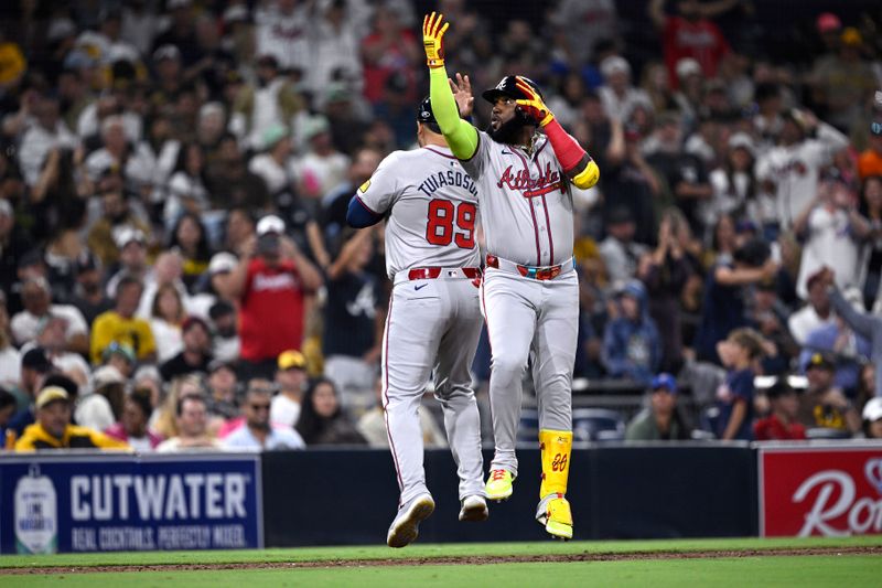 Jul 12, 2024; San Diego, California, USA; Atlanta Braves designated hitter Marcell Ozuna (20) celebrates with third base coach Matt Tuiasosopo (89) after hitting a home run against the San Diego Padres during the ninth inning at Petco Park. Mandatory Credit: Orlando Ramirez-USA TODAY Sports