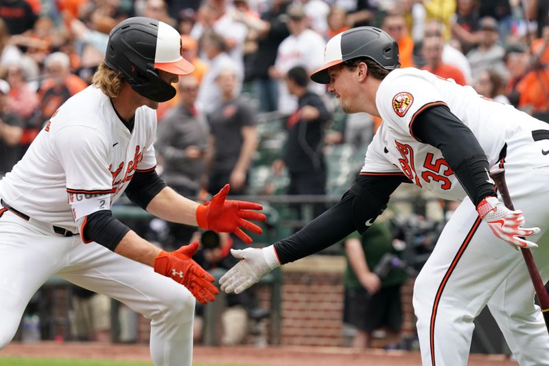 Apr 17, 2024; Baltimore, Maryland, USA; Baltimore Orioles shortstop Gunnar Henderson (2) greeted by catcher Adley Rutschman (35) following his solo home run in the first inning against the Minnesota Twins at Oriole Park at Camden Yards. Mandatory Credit: Mitch Stringer-USA TODAY Sports