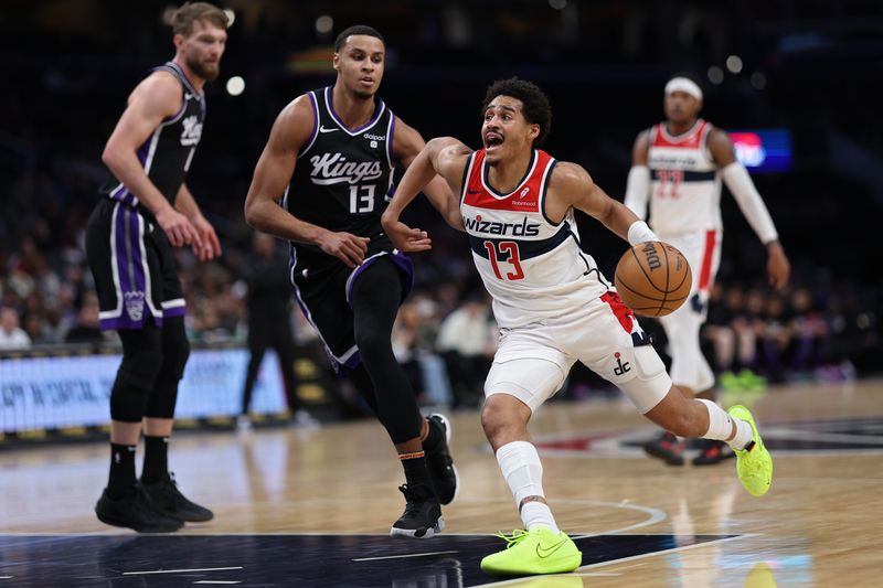 WASHINGTON, DC - MARCH 21: Jordan Poole #13 of the Washington Wizards dribbles past Keegan Murray #13 of the Sacramento Kings during the first half at Capital One Arena on March 21, 2024 in Washington, DC. NOTE TO USER: User expressly acknowledges and agrees that, by downloading and or using this photograph, User is consenting to the terms and conditions of the Getty Images License Agreement. (Photo by Patrick Smith/Getty Images)