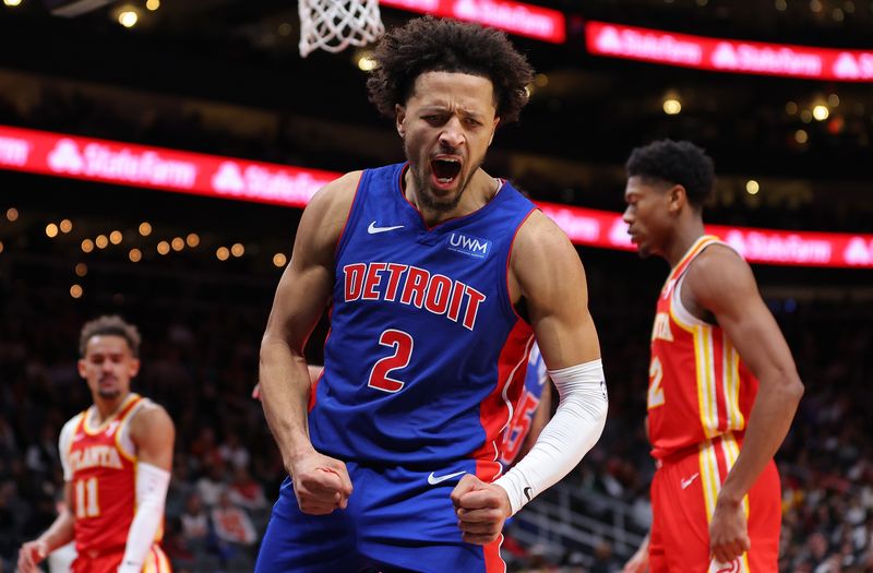 ATLANTA, GEORGIA - DECEMBER 18:  Cade Cunningham #2 of the Detroit Pistons reacts as he draws a foul after dunking against Trae Young #11 of the Atlanta Hawks during the fourth quarter at State Farm Arena on December 18, 2023 in Atlanta, Georgia.  NOTE TO USER: User expressly acknowledges and agrees that, by downloading and/or using this photograph, user is consenting to the terms and conditions of the Getty Images License Agreement.  (Photo by Kevin C. Cox/Getty Images)