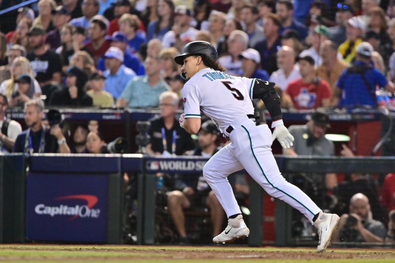 Nov 1, 2023; Phoenix, AZ, USA; Arizona Diamondbacks center fielder Alek Thomas (5) hits a single in the eighth inning against the Texas Rangers in game five of the 2023 World Series at Chase Field. Mandatory Credit: Matt Kartozian-USA TODAY Sports