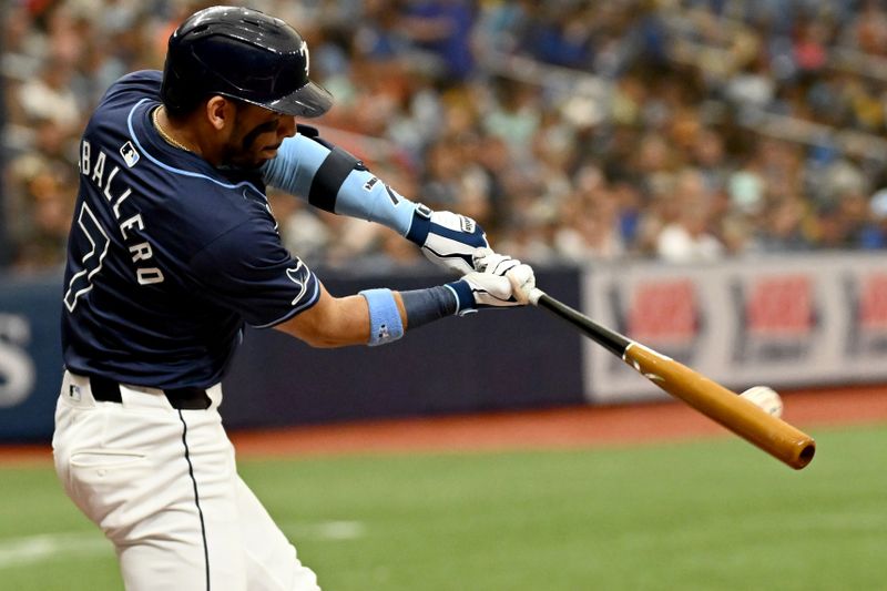 Jun 26, 2024; St. Petersburg, Florida, USA; Tampa Bay Rays short stop Jose Caballero (7) hits a double against the Seattle Mariners in the third inning at Tropicana Field. Mandatory Credit: Jonathan Dyer-USA TODAY Sports