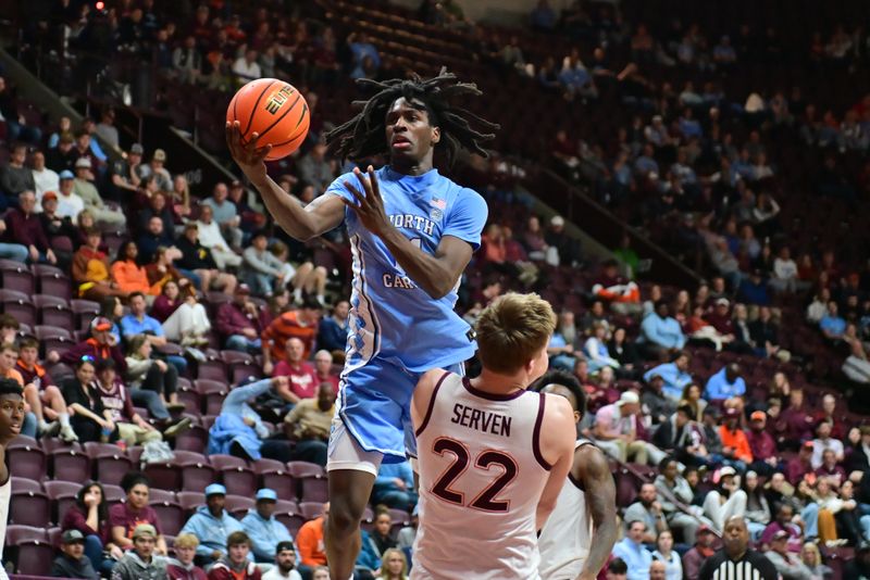 Mar 4, 2025; Blacksburg, Virginia, USA;  North Carolina Tar Heels guard RJ Davis (4) goes up for a shot as Virginia Tech Hokies forward Connor Serven (22) defends during the second half at Cassell Coliseum. Mandatory Credit: Brian Bishop-Imagn Images