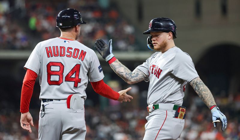 Aug 23, 2023; Houston, Texas, USA; Boston Red Sox right fielder Alex Verdugo (99) celebrates with first base coach/outfield instructor Kyle Hudson (84) after hitting a single during the fourth inning against the Houston Astros at Minute Maid Park. Mandatory Credit: Troy Taormina-USA TODAY Sports