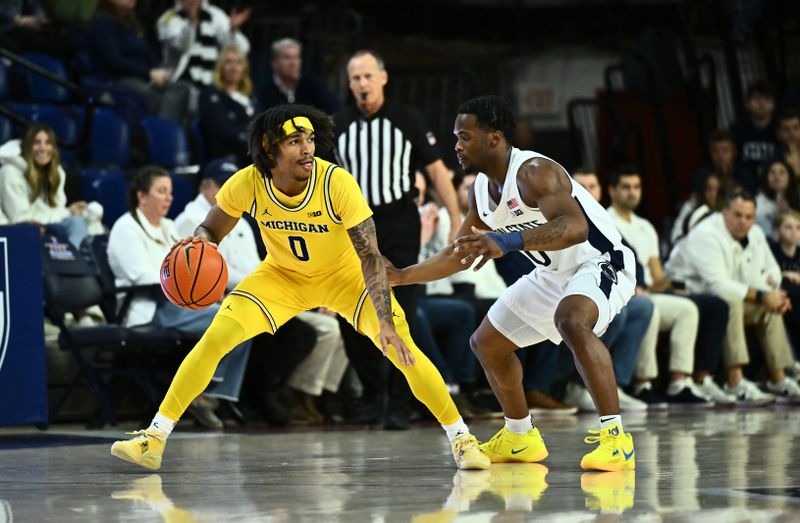 Jan 7, 2024; Philadelphia, Pennsylvania, USA; Michigan Wolverines guard Dug McDaniel (0) controls the ball against Penn State Nittany Lions guard Kanye Clary (0) in the first half at The Palestra. Mandatory Credit: Kyle Ross-USA TODAY Sports