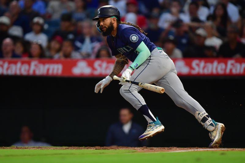 Jul 11, 2024; Anaheim, California, USA; Seattle Mariners shortstop J.P. Crawford (3) hits an RBI single against the Los Angeles Angels during the sixth inning at Angel Stadium. Mandatory Credit: Gary A. Vasquez-USA TODAY Sports