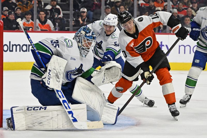 Dec 22, 2025; Philadelphia, Pennsylvania, USA; Vancouver Canucks goaltender Thatcher Demko (35) makes a save as Philadelphia Flyers right wing Bobby Brink (10) looks for the rebound during the second period at Xfinity Mobile Arena. Mandatory Credit: Eric Hartline-Imagn Images