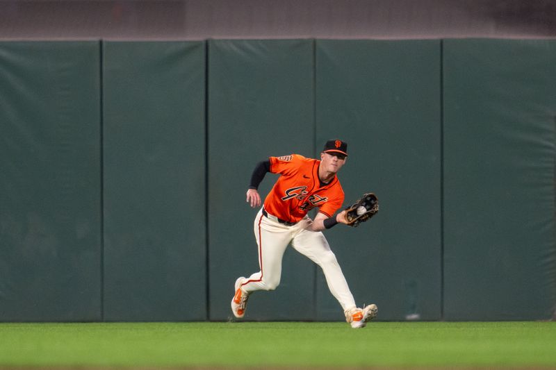 May 10, 2024; San Francisco, California, USA; San Francisco Giants center fielder Tyler Fitzgerald (49) fields a a fly ball against the Cincinnati Reds during the fifth inning  at Oracle Park. Mandatory Credit: Neville E. Guard-USA TODAY Sports