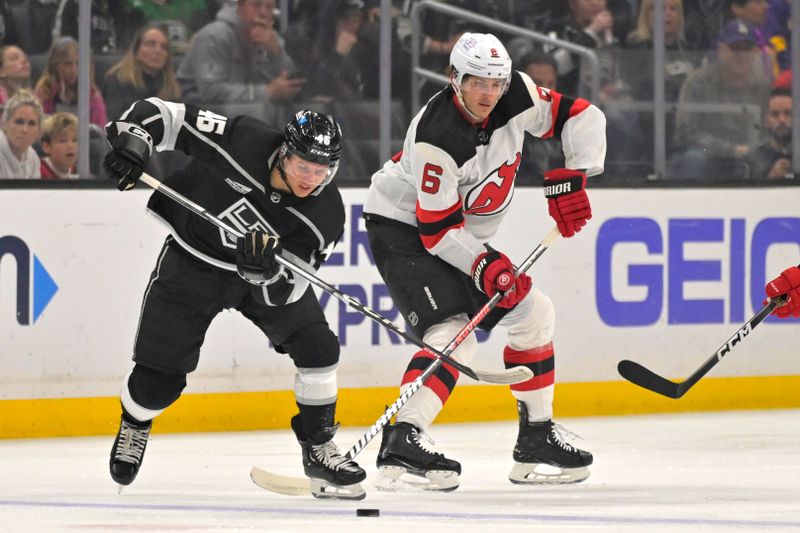 Mar 3, 2024; Los Angeles, California, USA; Los Angeles Kings center Blake Lizotte (46) and New Jersey Devils defenseman John Marino (6) go for the puck in the first period at Crypto.com Arena. Mandatory Credit: Jayne Kamin-Oncea-USA TODAY Sports