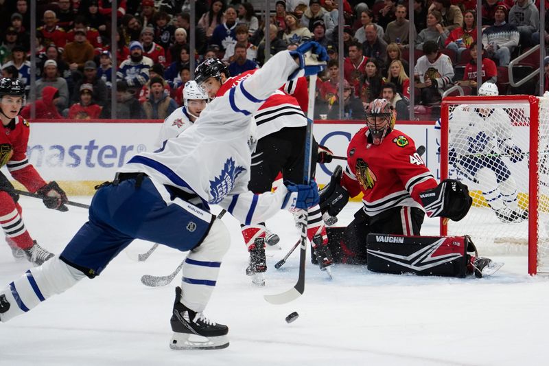 Nov 24, 2023; Chicago, Illinois, USA; Toronto Maple Leafs left wing Nicholas Robertson (89) shoots and scores on Chicago Blackhawks goaltender Arvid Soderblom (40) during the first period at United Center. Mandatory Credit: David Banks-USA TODAY Sports