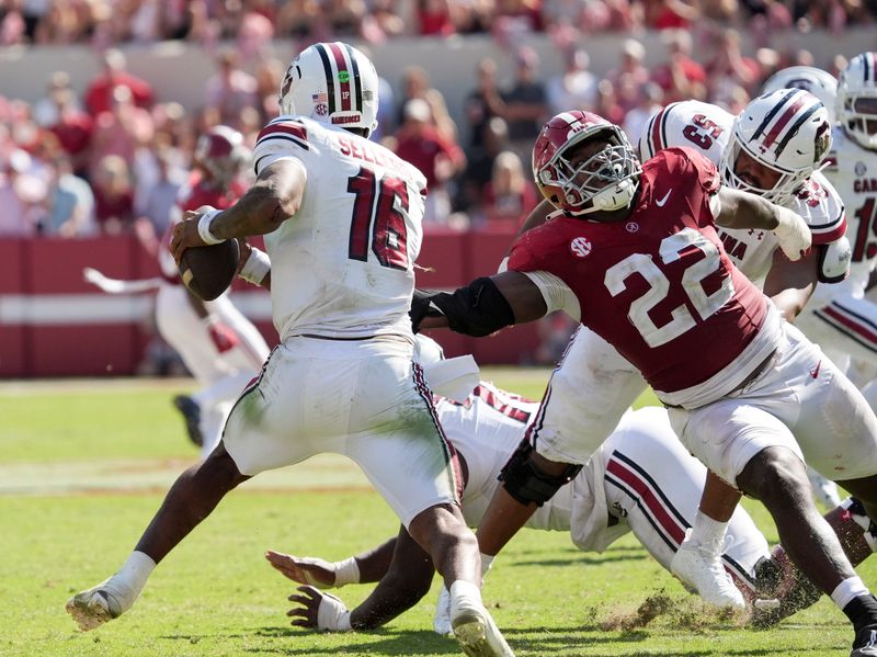 Oct 12, 2024; Tuscaloosa, Alabama, USA;  South Carolina Gamecocks quarterback LaNorris Sellers (16) evades a rush by Alabama Crimson Tide defensive lineman LT Overton (22) at Bryant-Denny Stadium. Alabama defeated South Carolina 27-25. Mandatory Credit: Gary Cosby Jr.-Imagn Images